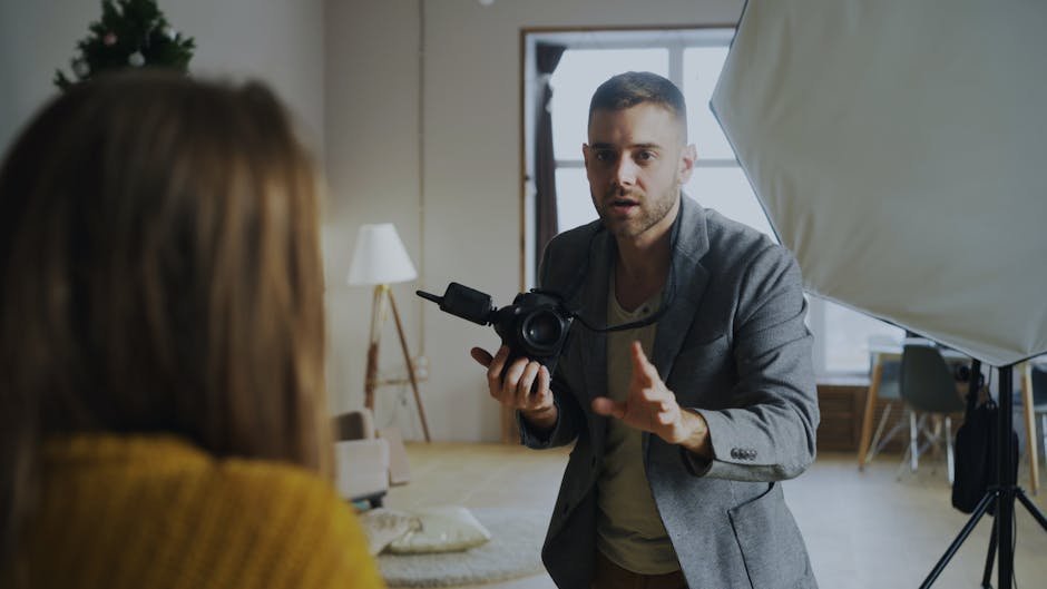 Lighting setup on a brand photoshoot with softbox, bounce cards, and photographer reviewing frames on a tethered monitor