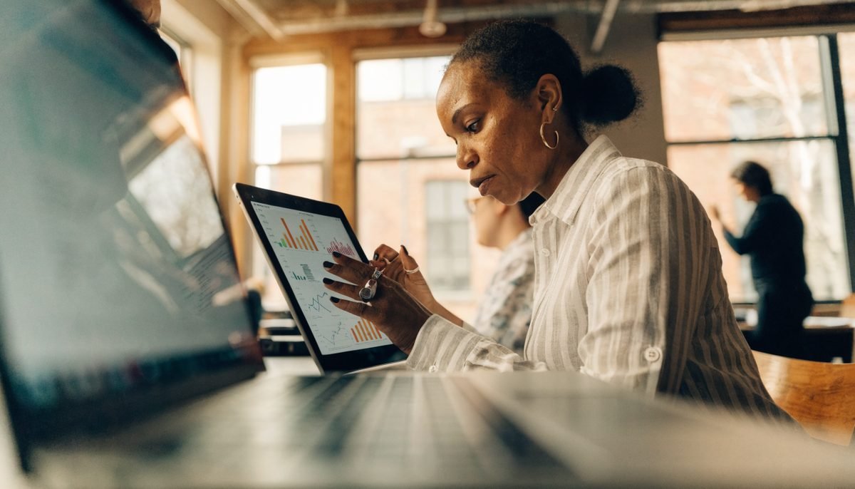 Toronto small business owner reviewing SEO analytics on a tablet in a modern coworking space