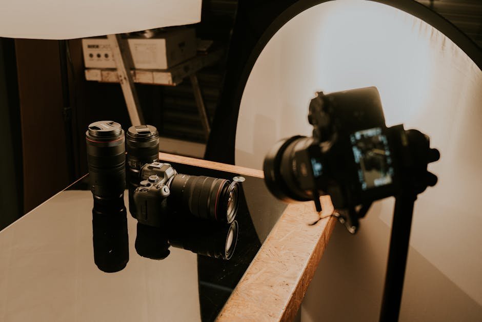 Professional ecommerce product photography studio setup with camera on tripod, softbox lighting, and styled product on seamless backdrop