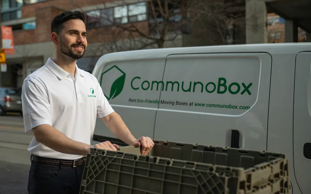 A small business owner standing beside his branded CommunoBox delivery van