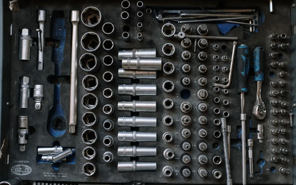 A socket wrench set laid out in a fitted tool case