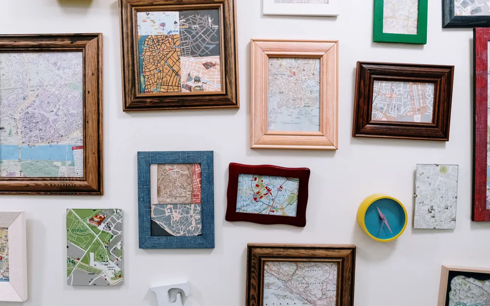 A wall hung with picture frames in many different sizes and shapes
