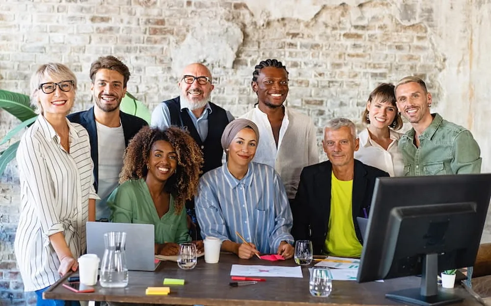 A team of colleagues gathered around a table in a working meeting