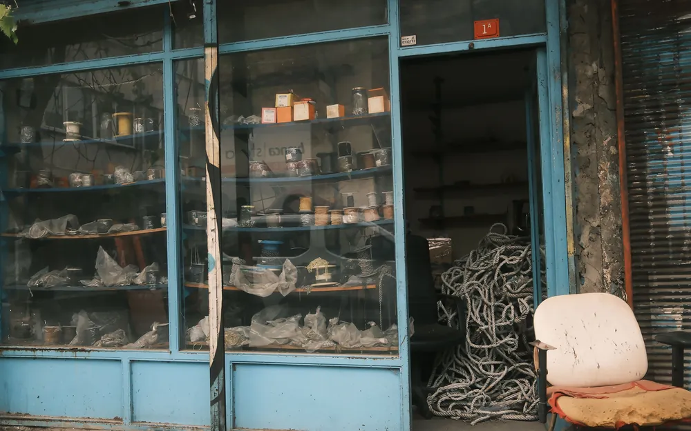 The interior of an old hardware store lined with stocked shelves and drawers