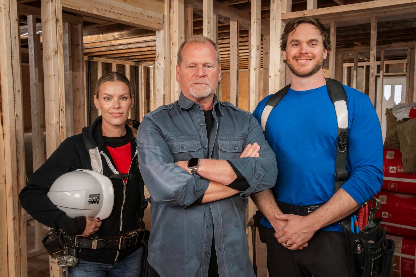 Mike Holmes with his inspection team on a home framing site — editorial portrait