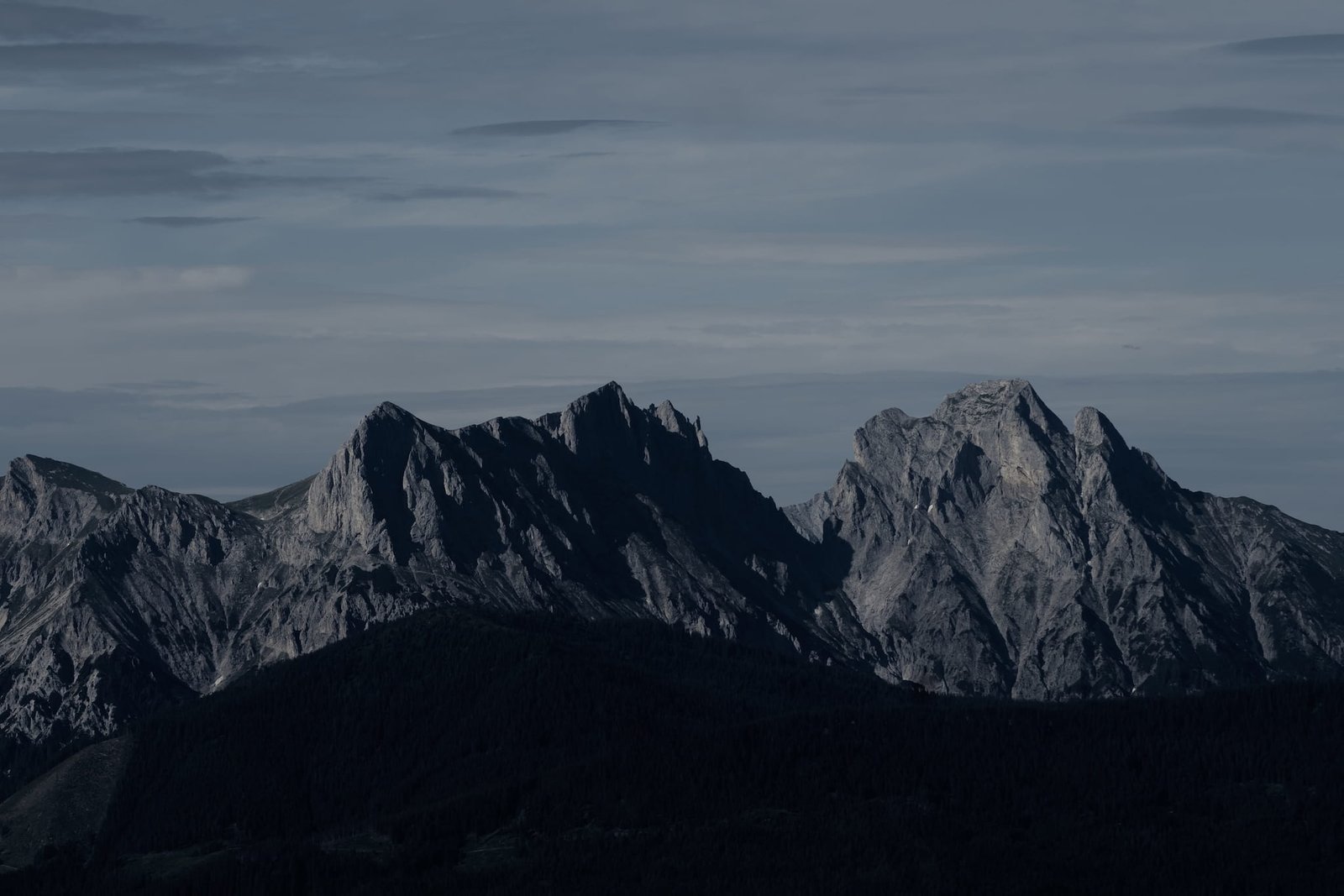 Wide view of a mountain range at dusk, seen from above