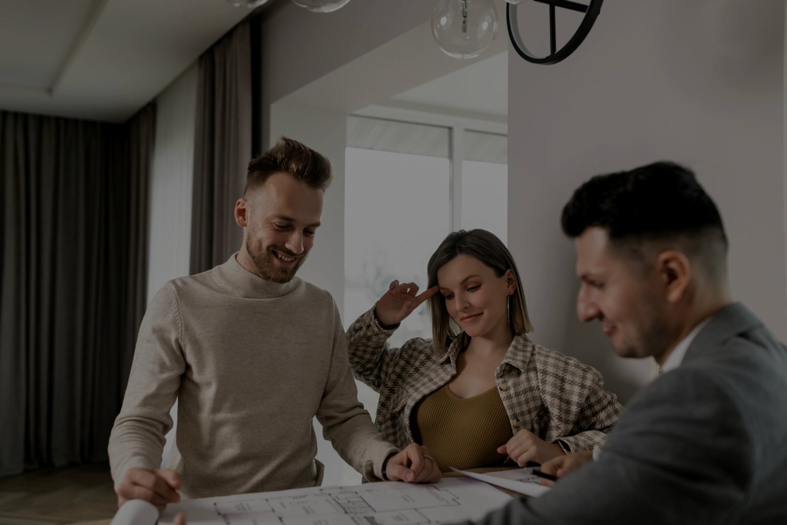 Three colleagues reviewing a marketing plan together at a desk
